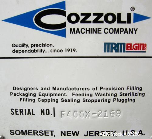 USED: Cozzoli heavy duty table top syringe filler, model F400X. Rated 0 to 50 cycles per minute. Max syringe size of 60ml, filling nozzle range 1.2mm to 6mm. Adjustable volume selector. Accurate with...