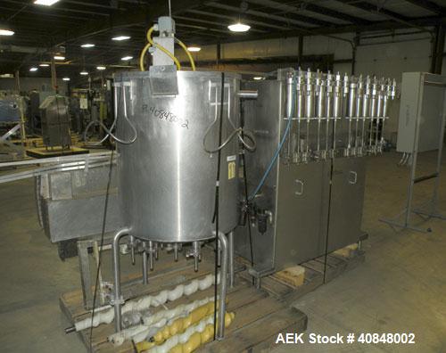 Used Filamatic (National Instruments) 12 Head In-Line Piston Filler. (12) 3/8’’ diameter nozzles with (9) centering bells, bottom up fill. (12) approximate 520cc pistons. Star wheel container indexin...