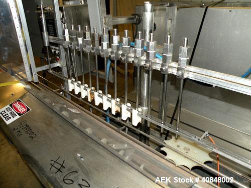 Used Filamatic (National Instruments) 12 Head In-Line Piston Filler. (12) 3/8’’ diameter nozzles with (9) centering bells, bottom up fill. (12) approximate 520cc pistons. Star wheel container indexin...