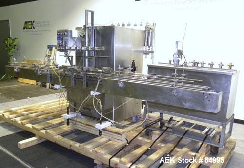 Used Filamatic Inline Piston Filler, Model CVK-300-1. Equipped with (8) 1000 cc pistons, all stainless steel. Automatic diving nozzle style, missing nozzles. Pneumatic container indexing. Self-contai...