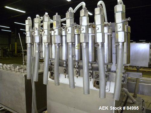 Used Filamatic Inline Piston Filler, Model CVK-300-1. Equipped with (8) 1000 cc pistons, all stainless steel. Automatic diving nozzle style, missing nozzles. Pneumatic container indexing. Self-contai...