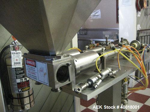 Used Hinds-Boch Twin Head Piston Filling Machine with hopper, on casters. Equipped withdual 32oz pistons, pneumatic foot pedal actuation.