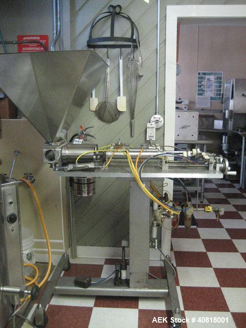 Used Hinds-Boch Twin Head Piston Filling Machine with hopper, on casters. Equipped withdual 32oz pistons, pneumatic foot pedal actuation.