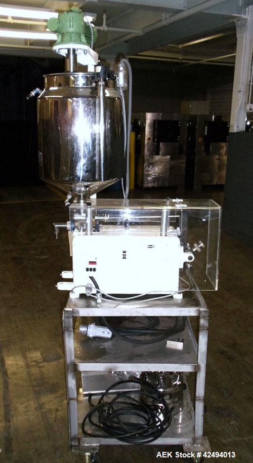 Used Kalix Single Head Piston Filler, Model 50MI, Stainless Steel. Single piston filling head, jacketed and agitated feed hopper, and foot pedal control. Mounted on a stand.