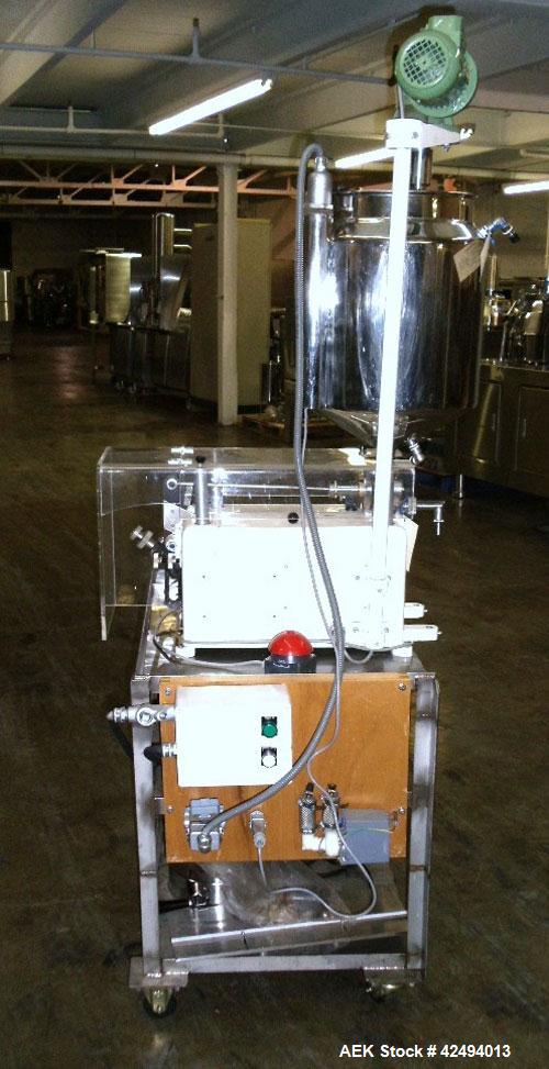 Used Kalix Single Head Piston Filler, Model 50MI, Stainless Steel. Single piston filling head, jacketed and agitated feed hopper, and foot pedal control. Mounted on a stand.
