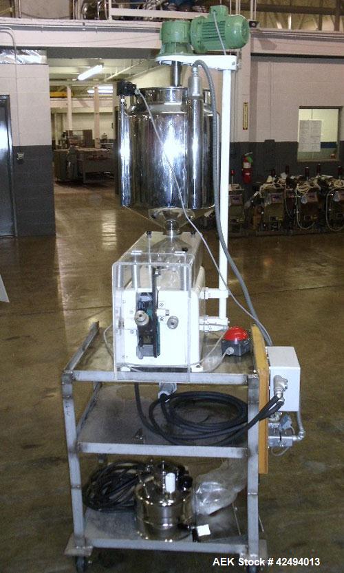 Used Kalix Single Head Piston Filler, Model 50MI, Stainless Steel. Single piston filling head, jacketed and agitated feed hopper, and foot pedal control. Mounted on a stand.