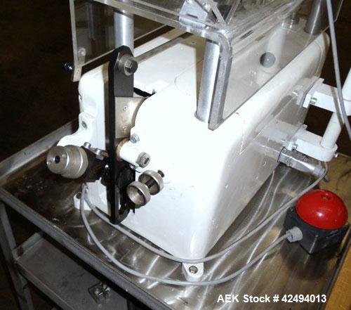 Used Kalix Single Head Piston Filler, Model 50MI, Stainless Steel. Single piston filling head, jacketed and agitated feed hopper, and foot pedal control. Mounted on a stand.