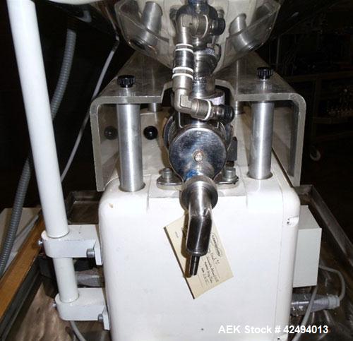 Used Kalix Single Head Piston Filler, Model 50MI, Stainless Steel. Single piston filling head, jacketed and agitated feed hopper, and foot pedal control. Mounted on a stand.