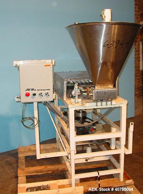 Used Simplex 4 Head Filler. Stainless steel nozzles 2" long x 3/16" opening, approximate 12 oz capacity per stroke, 28" diameter x 24" deep stainless steel hopper with cover. Mounted on a carbon stee...
