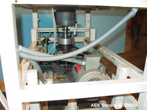 Used Simplex 4 Head Filler. Stainless steel nozzles 2" long x 3/16" opening, approximate 12 oz capacity per stroke, 28" diameter x 24" deep stainless steel hopper with cover. Mounted on a carbon stee...