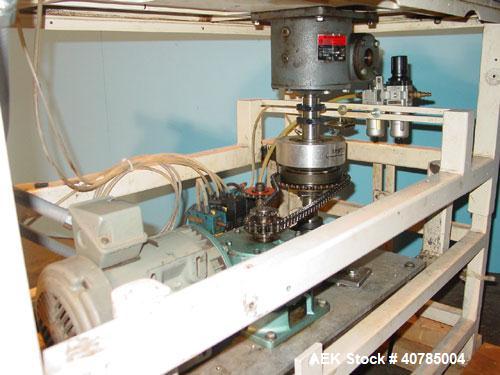 Used Simplex 4 Head Filler. Stainless steel nozzles 2" long x 3/16" opening, approximate 12 oz capacity per stroke, 28" diameter x 24" deep stainless steel hopper with cover. Mounted on a carbon stee...