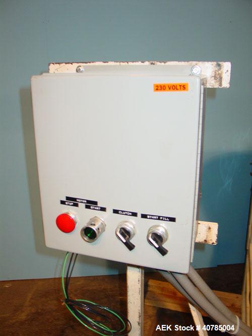 Used Simplex 4 Head Filler. Stainless steel nozzles 2" long x 3/16" opening, approximate 12 oz capacity per stroke, 28" diameter x 24" deep stainless steel hopper with cover. Mounted on a carbon stee...