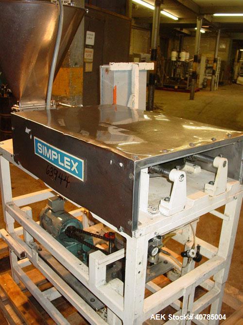 Used Simplex 4 Head Filler. Stainless steel nozzles 2" long x 3/16" opening, approximate 12 oz capacity per stroke, 28" diameter x 24" deep stainless steel hopper with cover. Mounted on a carbon stee...