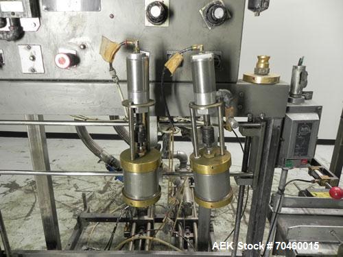 Used Thiele Model AF-2T-B1 Two Head PD Filler. Filler is designed to fill Quart to Gallon containers, (actual range 4 oz min to 185 oz maximum) at rates of 30-400 quart/min & 20-30 gallon/min. Each f...