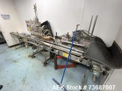 Used KapsAll Model VOL-32-8 Inline Piston Filler. (8) head units with 36oz pistons, positive shut-off nozzles, 6"W x 12'L co...