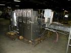 Used Filamatic (National Instruments) 12 Head In-Line Piston Filler. (12) 3/8’’ diameter nozzles with (9) centering bells, bottom up fill. (12) approximate 520cc pistons. Star wheel container indexin...