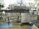 Used Filamatic 4 head inline piston filler. Has pin indexing system, bottom up fill, 240cc pistons, 10'L conveyor. Mounted on casters.