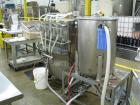 Used Filamatic 4 head inline piston filler. Has pin indexing system, bottom up fill, 240cc pistons, 10'L conveyor. Mounted on casters.