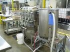 Used- Filamatic 4 head inline piston filler. Has pin indexing system, bottom up fill, 240cc pistons, 10'L conveyor. Mounted ...