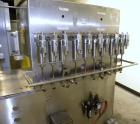 Used Filamatic (National Instruments) 10 Head In-Line Piston Filler, Model AL-800HS. No nozzles or centering bells, bottom up fill. (10) approximate 260cc pistons. Conveyor infeed and discharge. Incl...