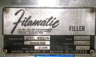 Used Filamatic (National Instruments) 10 Head In-Line Piston Filler, Model AL-800HS. No nozzles or centering bells, bottom up fill. (10) approximate 260cc pistons. Conveyor infeed and discharge. Incl...