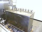 Used Filamatic Inline Piston Filler, Model CVK-300-1. Equipped with (8) 1000 cc pistons, all stainless steel. Automatic diving nozzle style, missing nozzles. Pneumatic container indexing. Self-contai...