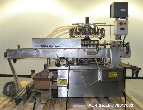 Used Biner Ellison Versamatic 12 Head Rotary Liquid Positive Displacement Filler, Model V 26-12. (12) 1/2" diameter nozzles on approximately 7" centers. Worm screw to starwheel infeed; left to right ...