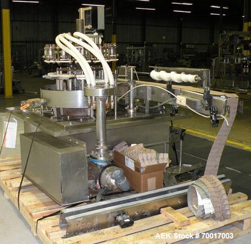 Used Biner Ellison Versamatic 12 Head Rotary Liquid Positive Displacement Filler, Model V 26-12. (12) 1/2" diameter nozzles on approximately 7" centers. Worm screw to starwheel infeed; left to right ...