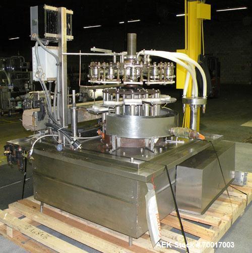 Used Biner Ellison Versamatic 12 Head Rotary Liquid Positive Displacement Filler, Model V 26-12. (12) 1/2" diameter nozzles on approximately 7" centers. Worm screw to starwheel infeed; left to right ...
