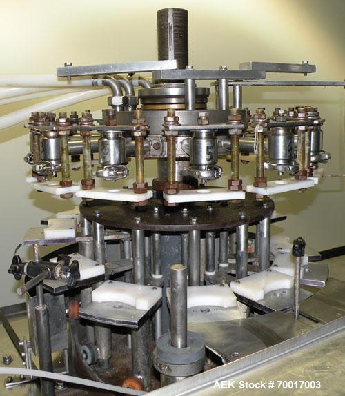 Used Biner Ellison Versamatic 12 Head Rotary Liquid Positive Displacement Filler, Model V 26-12. (12) 1/2" diameter nozzles on approximately 7" centers. Worm screw to starwheel infeed; left to right ...