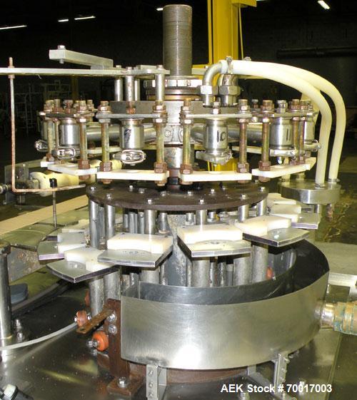 Used Biner Ellison Versamatic 12 Head Rotary Liquid Positive Displacement Filler, Model V 26-12. (12) 1/2" diameter nozzles on approximately 7" centers. Worm screw to starwheel infeed; left to right ...