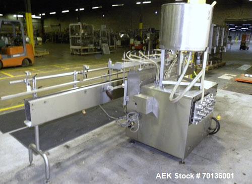 Used Kalish Kalishtronic Model KT12 Positive Displacement Filler. Currentlyt set up with 8 pumps and filling nozzles. Has neck guides, positive shut off nozzles, pin indexing and table top chain conv...
