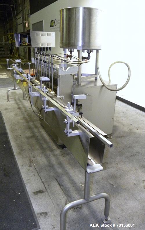 Used Kalish Kalishtronic Model KT12 Positive Displacement Filler. Currentlyt set up with 8 pumps and filling nozzles. Has neck guides, positive shut off nozzles, pin indexing and table top chain conv...