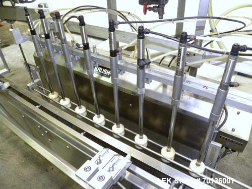 Used Kalish Kalishtronic Model KT12 Positive Displacement Filler. Currentlyt set up with 8 pumps and filling nozzles. Has neck guides, positive shut off nozzles, pin indexing and table top chain conv...