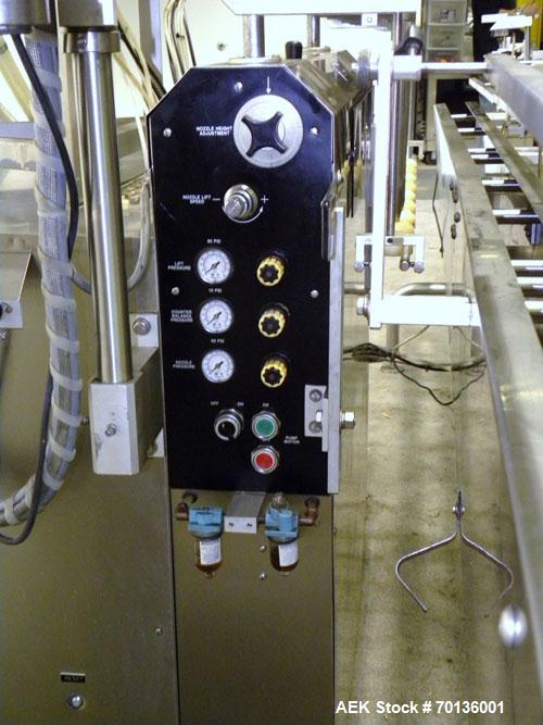 Used Kalish Kalishtronic Model KT12 Positive Displacement Filler. Currentlyt set up with 8 pumps and filling nozzles. Has neck guides, positive shut off nozzles, pin indexing and table top chain conv...