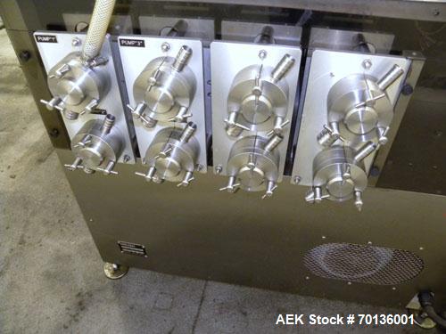 Used Kalish Kalishtronic Model KT12 Positive Displacement Filler. Currentlyt set up with 8 pumps and filling nozzles. Has neck guides, positive shut off nozzles, pin indexing and table top chain conv...