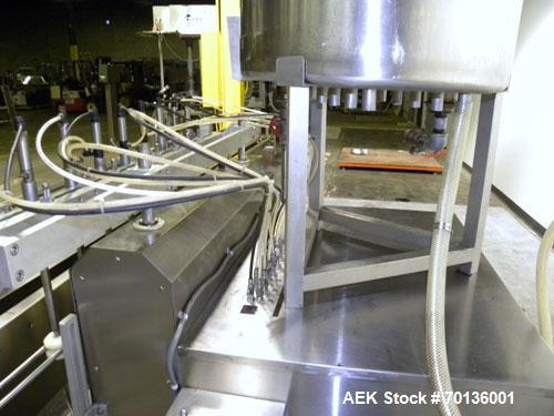 Used Kalish Kalishtronic Model KT12 Positive Displacement Filler. Currentlyt set up with 8 pumps and filling nozzles. Has neck guides, positive shut off nozzles, pin indexing and table top chain conv...