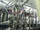 Used Oden Profil 1000 6-Head Inline Volumetric Filler. This unit features six (6) Waukesha Model 15 universal pumps and is currently set up with 1 inch diameter positive shut off nozzles. Pin Indexin...
