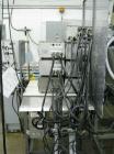 Used Oden Profil 1000 6-Head Inline Volumetric Filler. This unit features six (6) Waukesha Model 15 universal pumps and is currently set up with 1 inch diameter positive shut off nozzles. Pin Indexin...