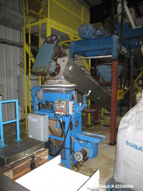 Used Arcopak Auger Bag Packer, Model Augerpack ERC-1010. Agitated feed hopper, carbon steel spout, stainless steel auger, 5 hp, 575 volt motor.