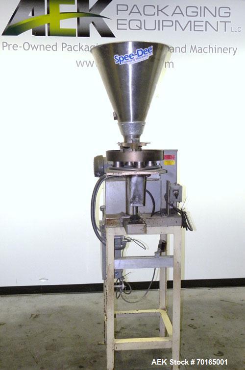 Used Spee-Dee 4-Pocket Volumetric Cup Filler. Has approximately (4) 2" diameter cups with stainless steel supply hopper mounted on base. Machine also has automatic indexing. Mounted on a carbon steel...