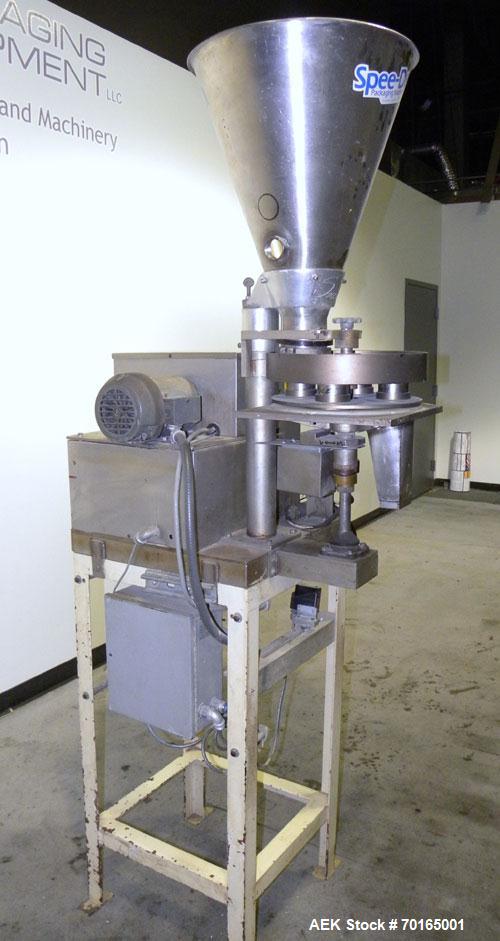 Used Spee-Dee 4-Pocket Volumetric Cup Filler. Has approximately (4) 2" diameter cups with stainless steel supply hopper mounted on base. Machine also has automatic indexing. Mounted on a carbon steel...