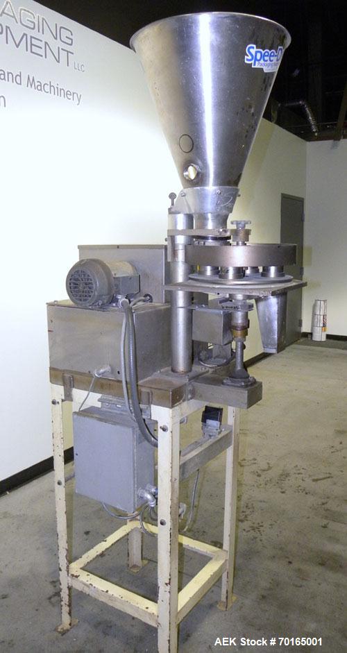 Used- Spee-Dee 4-Pocket Volumetric Cup Filler. Has approximately (4) 2" diameter cups with stainless steel supply hopper mou...