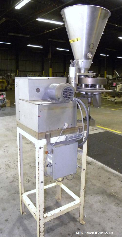 Used Spee-Dee 4-Pocket Volumetric Cup Filler. Has approximately (4) 2" diameter cups with stainless steel supply hopper mounted on base. Machine also has automatic indexing. Mounted on a carbon steel...