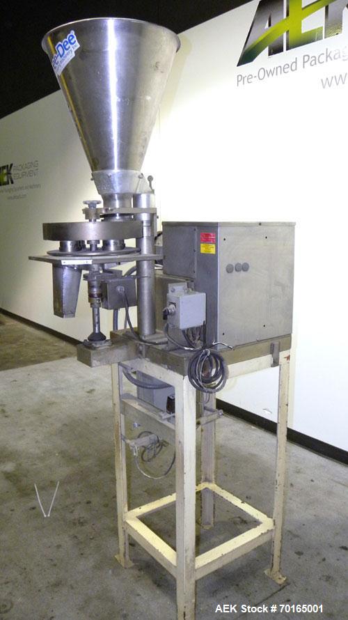 Used Spee-Dee 4-Pocket Volumetric Cup Filler. Has approximately (4) 2" diameter cups with stainless steel supply hopper mounted on base. Machine also has automatic indexing. Mounted on a carbon steel...