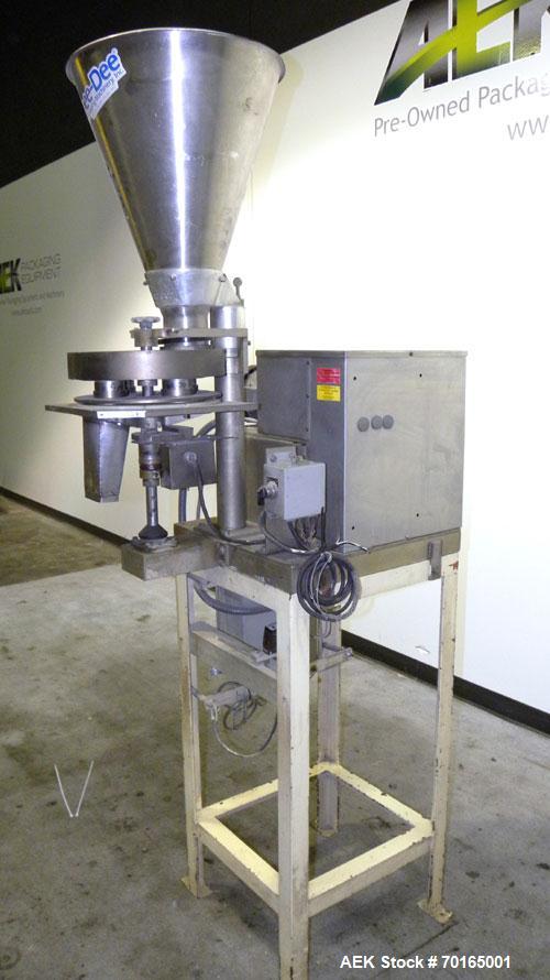 Used- Spee-Dee 4-Pocket Volumetric Cup Filler. Has approximately (4) 2" diameter cups with stainless steel supply hopper mou...