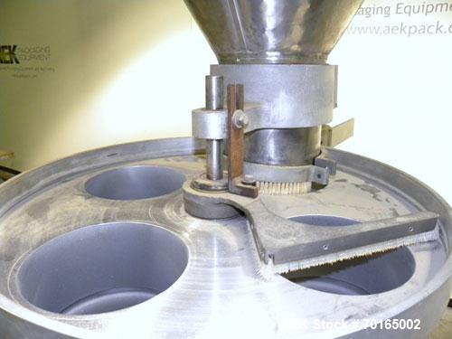 Used Spee-Dee Model KRE-468 4-Pocket Volumetric Cup Filler. Fixed speed 30 per minute. Has (4) 8" diameter 13" tall cup plates with a 4" vertical top plate adjustment. Machine has a 5.6 cubic foot st...