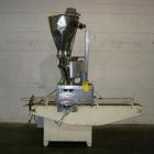 Used Spee-Dee Automatic Volumetric Cup Filler, Model CB4. Has 4 pockets with a dual discharge. Cup size range: diameter 1