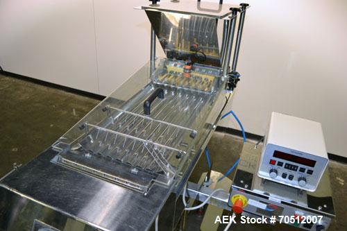 Used King Model TC8 Electronic Tablet Counter. Capable of speeds up to 60 bottles per minute depending on count and container size. Has two trays with 8 channels, pin indexing system and conveyor. Du...