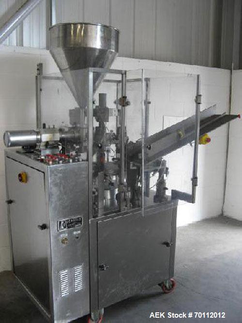 Used Comadis C-125 Plastic and Metal Tube Filler, rotary valve piston tube filler